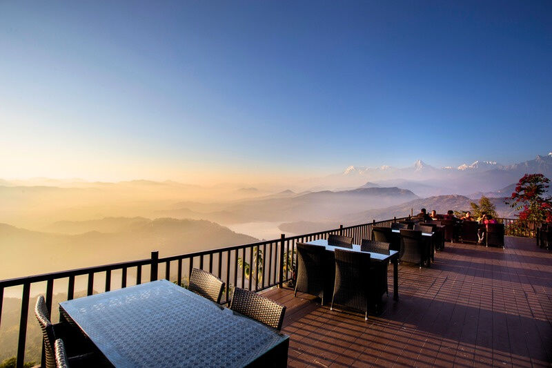 Outdoor deck at Rupakot Resort at first light, looking out over the hills